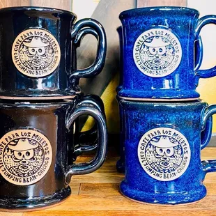 three coffee mugs on a shelf