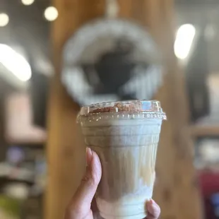 a hand holding a cup of coffee