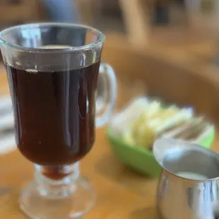 This is how coffee is served in this smooth glass cup