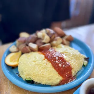 an omelet with a side of fruit and nuts