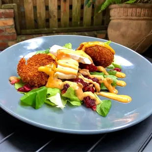 CRAB CAKES - $13.99 - Two Fresh Blue Lump Crab Cakes on Farm Fresh Spring Greens with Brie, Home-made Cranberry Relish and Spicy Remoulade.