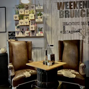 two leather chairs and a table