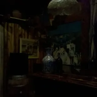 a table with a vase and a lamp