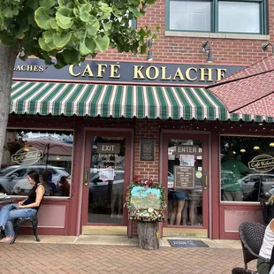 people sitting outside a cafe