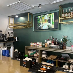 a coffee bar with a television on the wall