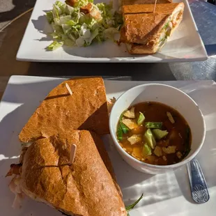 Back: Chicken chipotle sandwich with a Caesar salad side  Front: Roasted turkey sandwich with the chicken tortilla soup