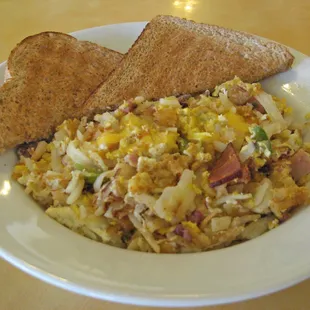 The infamous KITCHEN SINK (Homemade Hash-browns scrambled with eggs, bacon, ham,  bell pepper &amp; onion. * topped with cheese)