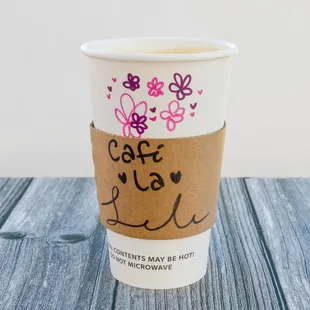 a coffee cup with a sticker on it