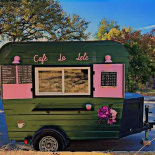 a green and pink food truck