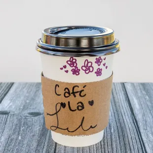 a cup of coffee on a wooden table