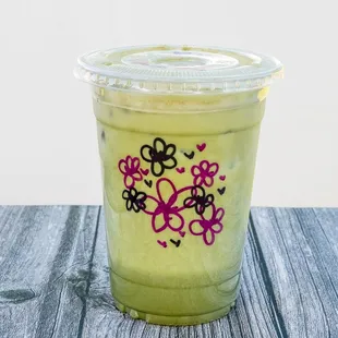 a green smoothie in a plastic cup