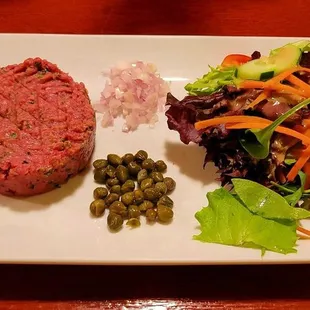 a plate of food with meat and vegetables