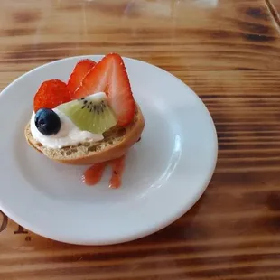 a fruit tart with whipped cream and strawberries