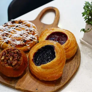 Arley&apos;s pastries: Cinnamon Roll, Pecan Sticky bun, &amp; Rotating Danishes.