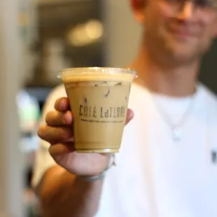 a man holding a cup of coffee