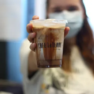 a woman holding a cup of coffee