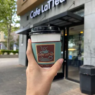 a hand holding a cup of coffee