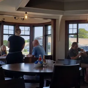 people sitting at tables in a restaurant