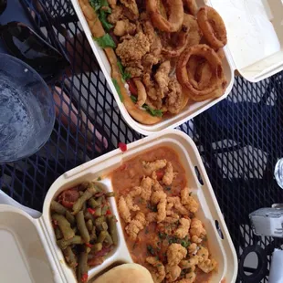 Oyster Po-boy with onion rings on the top and the crawfish half and half on the bottom with green beans and soft hot bread.