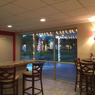 View of patio area and courtyard/rooms from inside the restaurant.