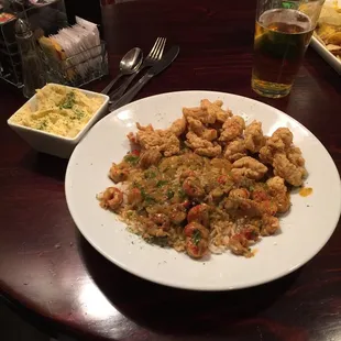 Half crawfish étouffée half fried crawfish with side potato salad.