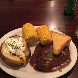 Hamburger Steak, loaded baked potato, corn on the cob, Texas Toast.