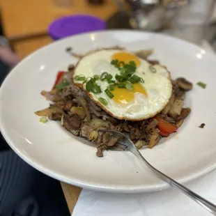 Steak hash with sunny side up eggs.