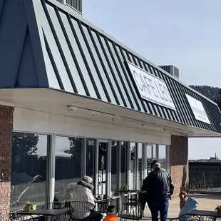 people walking in front of a restaurant