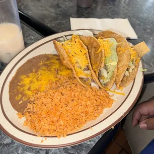 Three taco combination plate with rice and beans
