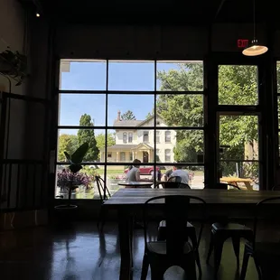 a table and chairs in front of a large window