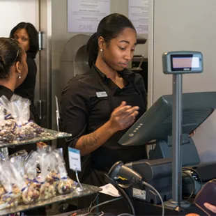 a woman paying food at a counter