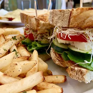 Veggie Feta on Sourdough: Greek feta cheese, alfalfa sprouts, cucumber, Roma tomatoes, lettuce &amp; garlic basil sauce. served with fries