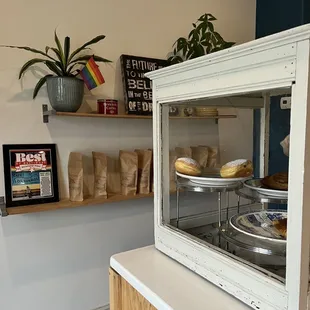a display of pastries in a glass case