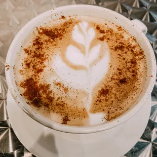 Hot Latte with art, one of many of our signature coffees we offer with milk and syrup options to personalize!