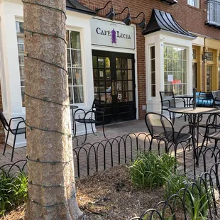 tables and chairs in front of a building