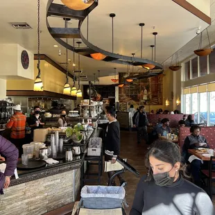 people sitting at tables in a restaurant