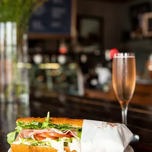 a sandwich and a glass of champagne