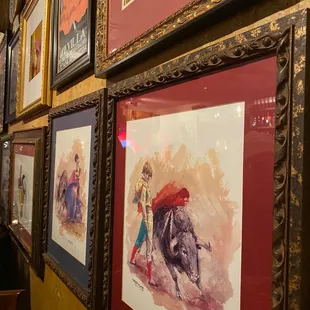 a wall full of framed art