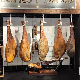 a display of meat hanging from hooks