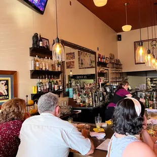 a group of people sitting at a bar