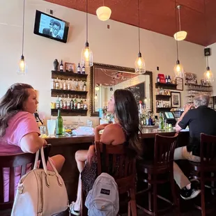 a group of people sitting at a bar