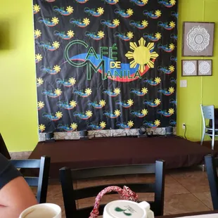 a man sitting at a table with a cup of coffee