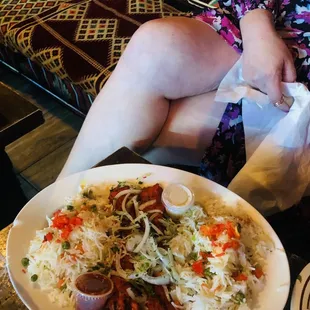 a woman sitting on a couch with a plate of food