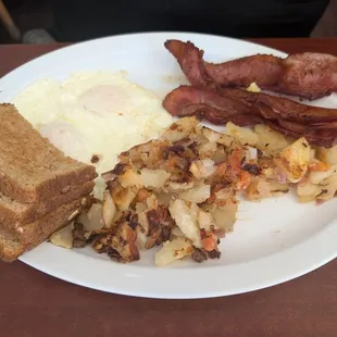 Eggs over easy with bacon and home fries