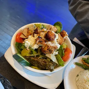 a bowl of salad and a plate of rice