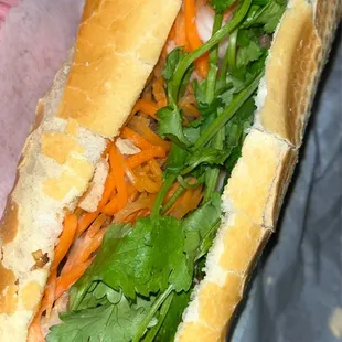 a sub sandwich with meat and vegetables