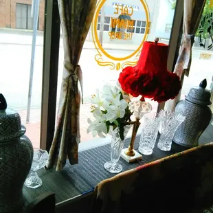 a vase of flowers in front of a window