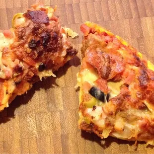 Supreme, cut into squares on thin crust, with many toppings