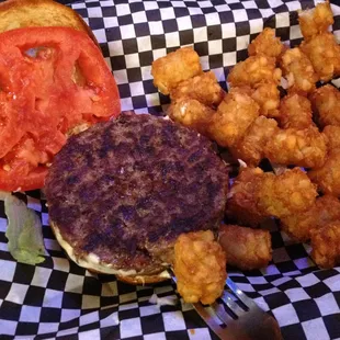 Didn't get the angle right, but the 1/4 lb Black Angus steak burger patty was almost as thick as my tot.