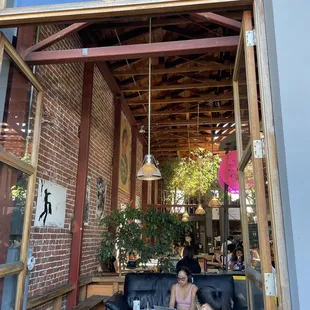 a woman sitting on a black leather couch